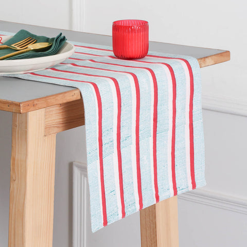 Red and green stripe block printed cotton table runner styled on a dining table, creating a vibrant table setting and dining table décor for everyday and festive meals