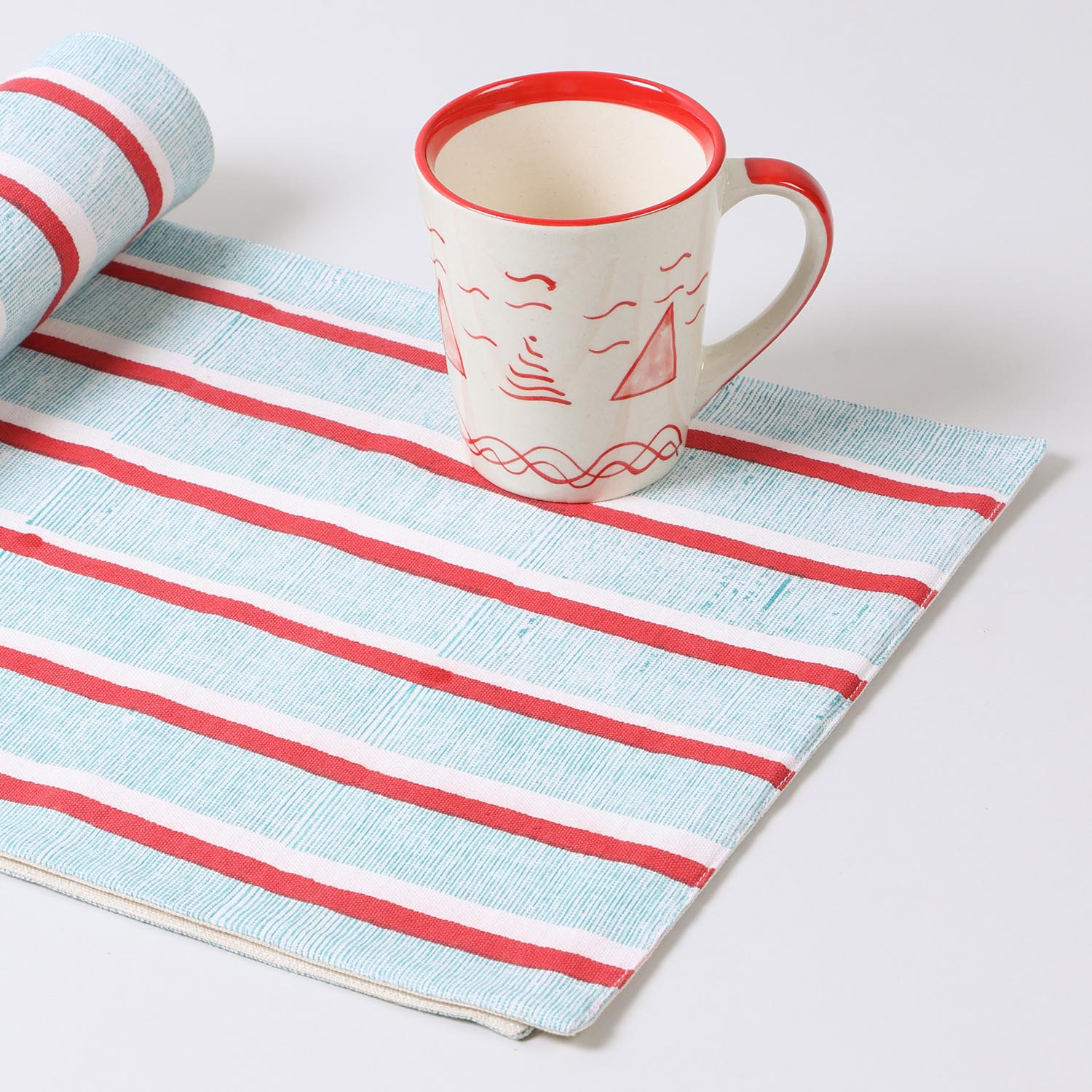 Hand-block-printed cotton table runner with red and green stripes displayed as a decorative home décor accent