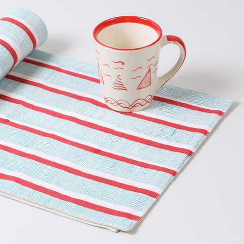 Hand-block-printed cotton table runner with red and green stripes displayed as a decorative home décor accent