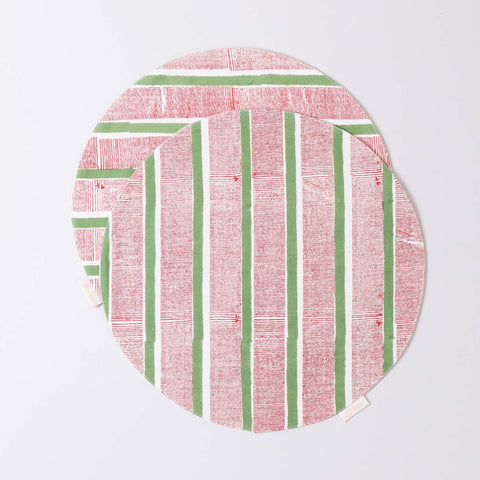 Set of 2 round cotton placemats featuring red and green stripe block printed designs displayed on a plain background
