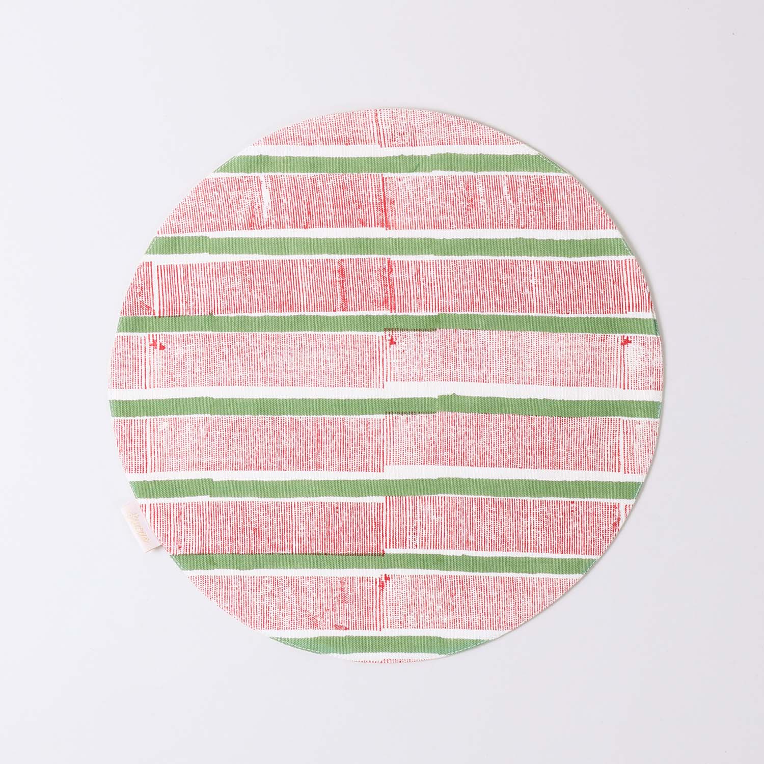 Round cotton table mat with red and green stripe block print pattern handcrafted by Indian artisans