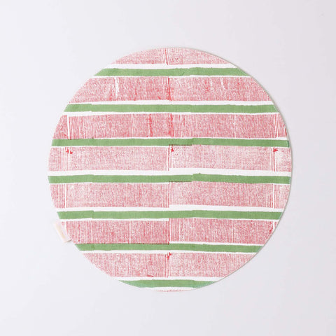 Round cotton table mat with red and green stripe block print pattern handcrafted by Indian artisans