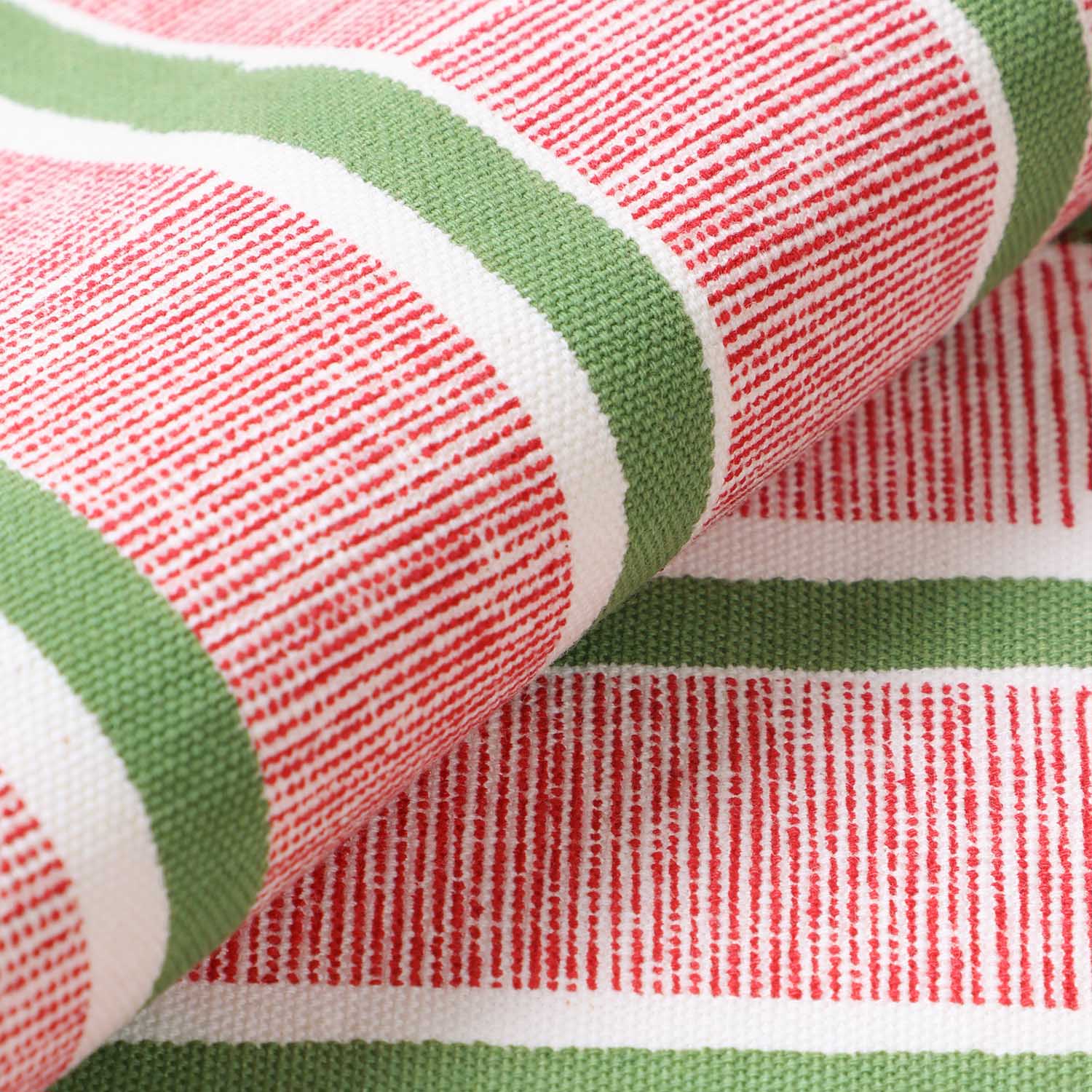 Detailed view of cotton placemat fabric with red and green stripe block print design highlighting durable handcrafted construction