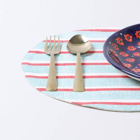 Handmade cotton placemat arranged with dinnerware on a dining table, creating a colourful dining table setting and table décor