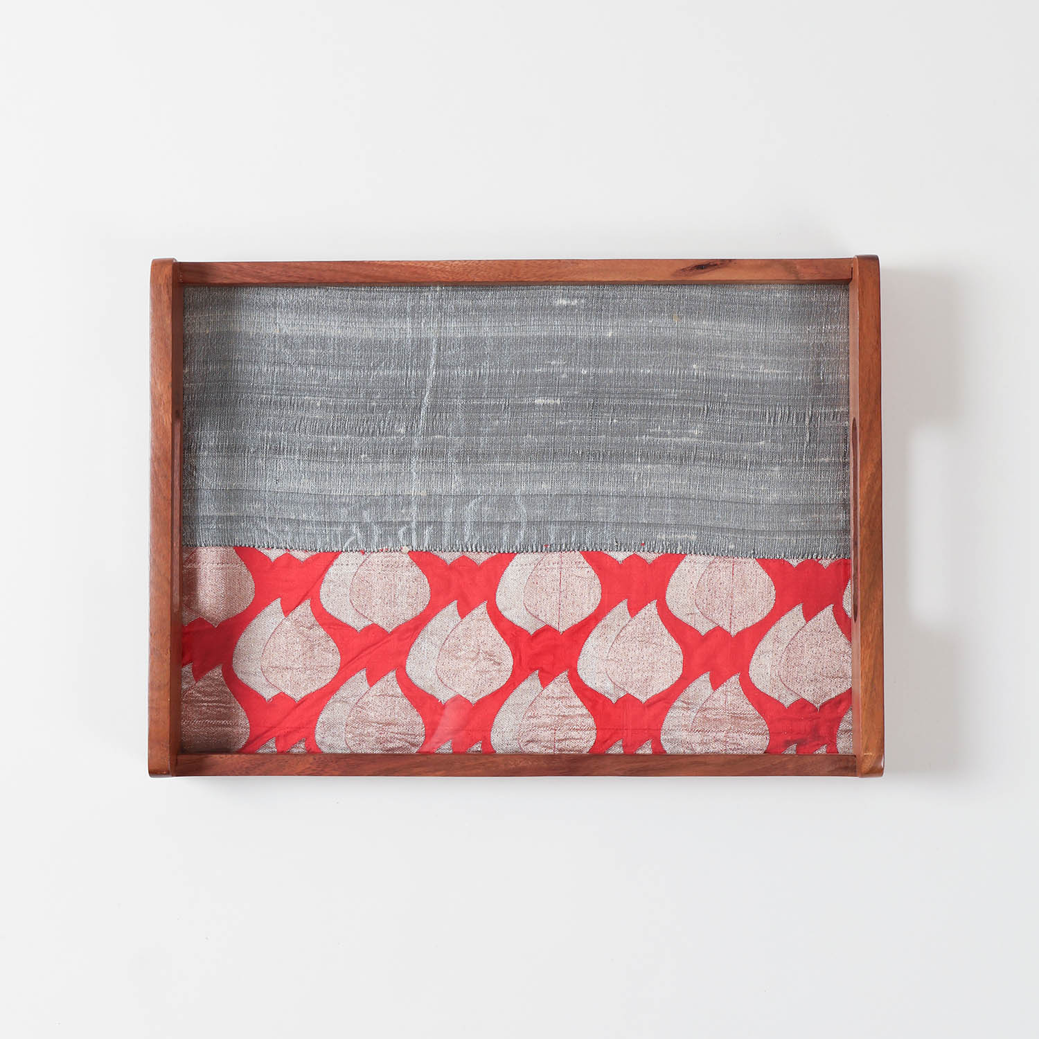 Empty rectangular sheesham wood serving tray with red and grey fabric base displayed on a plain background