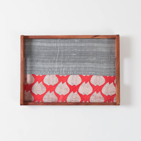 Empty rectangular sheesham wood serving tray with red and grey fabric base displayed on a plain background