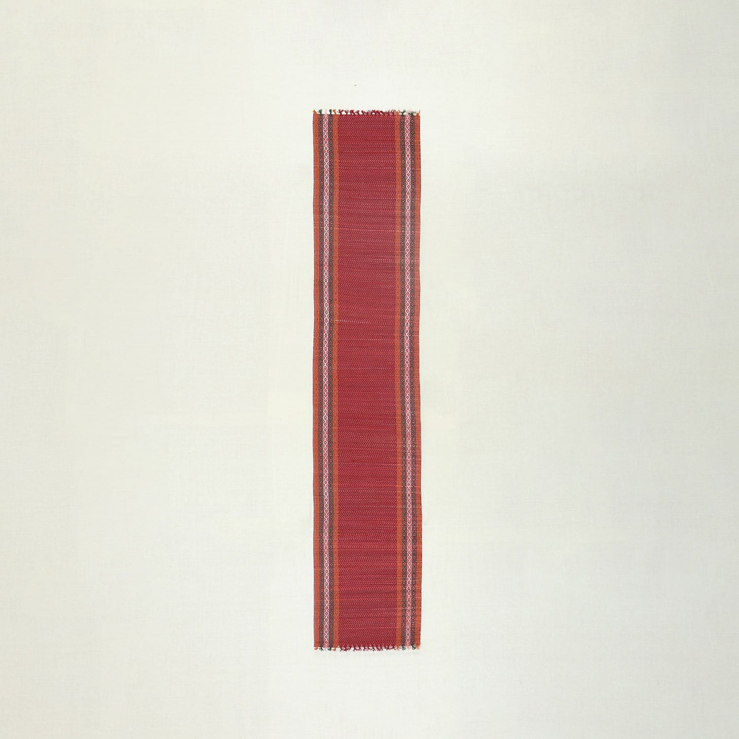 Full-length handmade red Madhurkathi table runner crafted from natural river grass, ideal for dining table decor and table settings