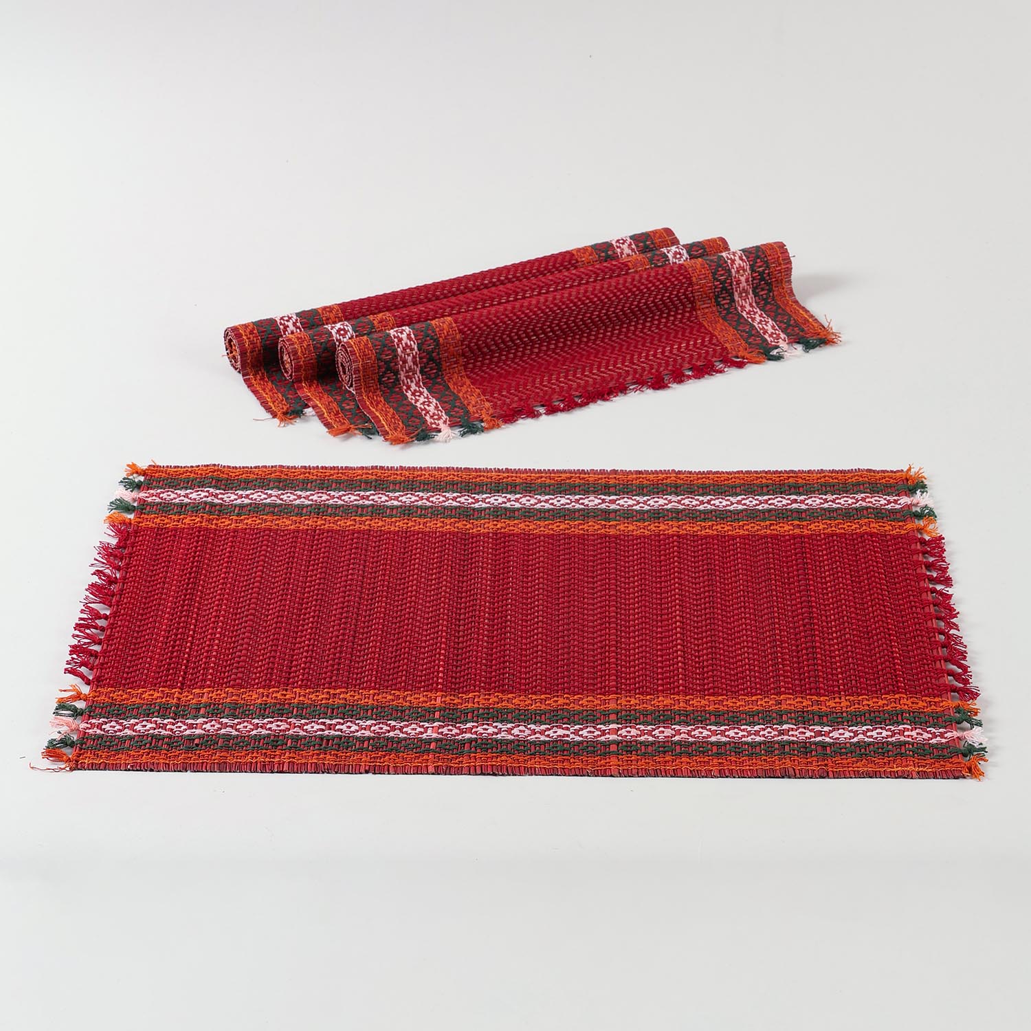 Red natural fibre placemats crafted from Madurkathi grass, displayed as a dining table mat set of 4 with a handwoven texture