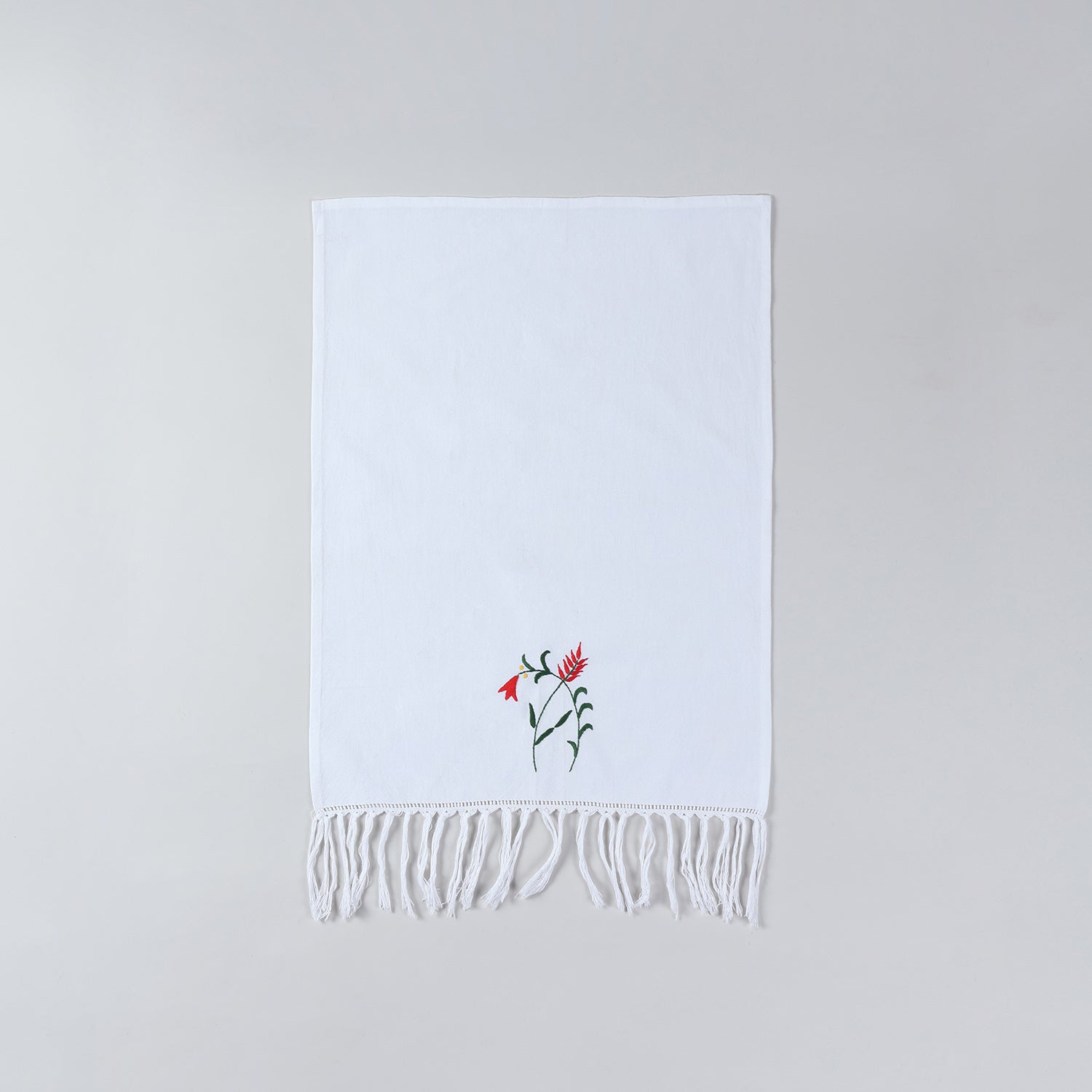 Full size white cotton kitchen hand towel with handcrafted floral embroidery and decorative tasselled border