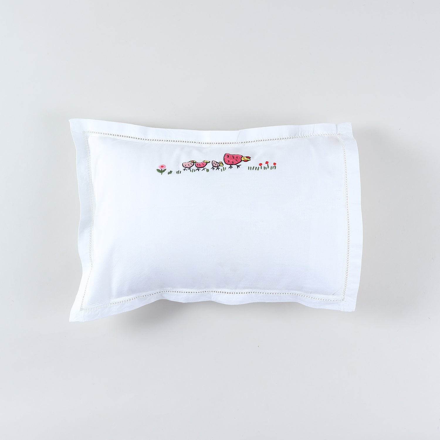 Kids pillow cover with colourful rooster with its family hand embroidery on a white cotton base from the handmade kids bedding collection