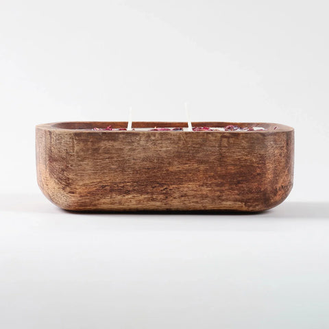 Eye level view of a wooden tub filled with rose scented natural soy wax