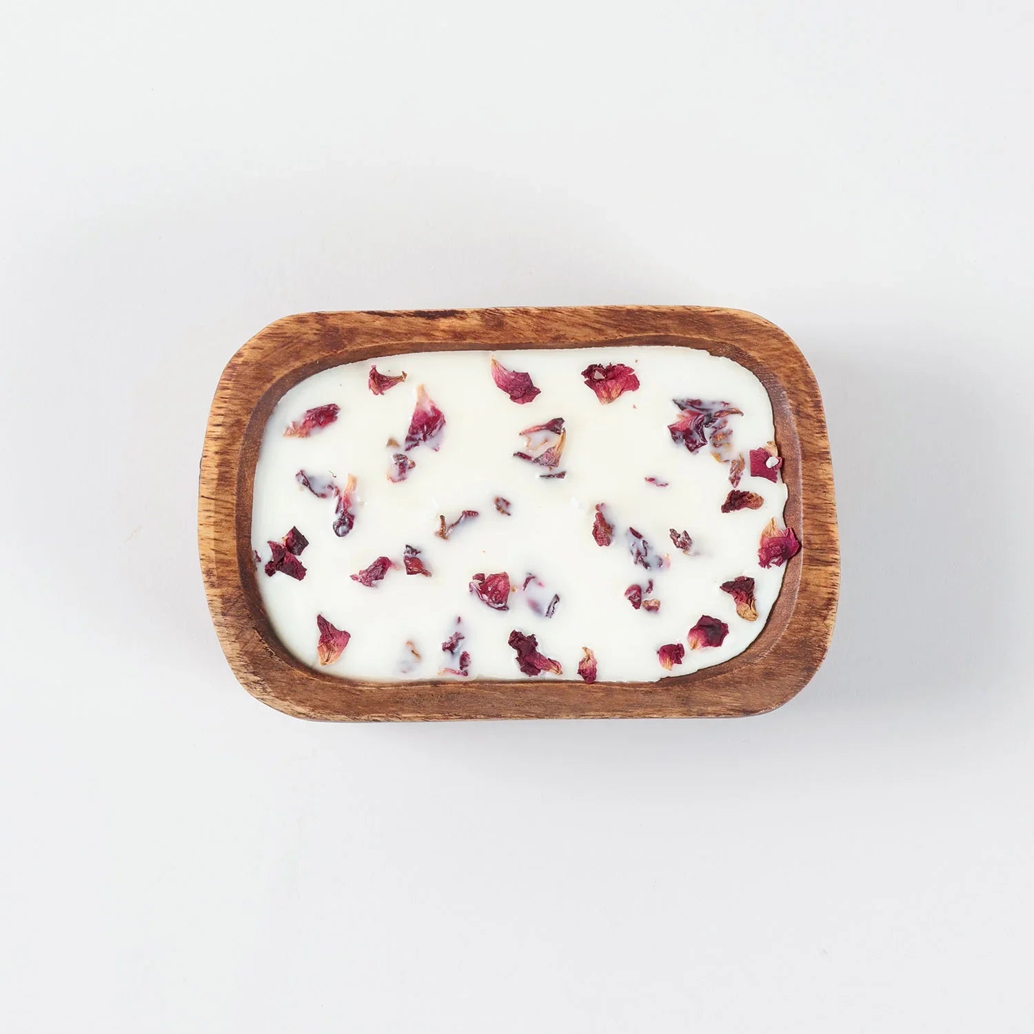 Top view of a wooden tub filled with rose scented natural soy wax