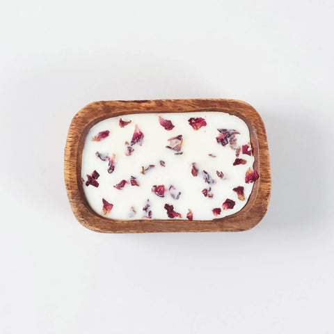 Top view of a wooden tub filled with rose scented natural soy wax
