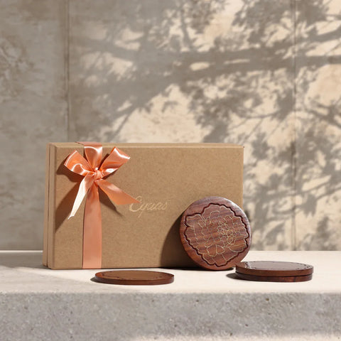 Rosewood coaster gift set with marigold floral brass inlay, beautifully styled as a festive gift with elegant packaging