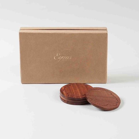 Premium gift presentation of handcrafted rosewood coasters with marigold floral brass inlay arranged in a decorative gift box