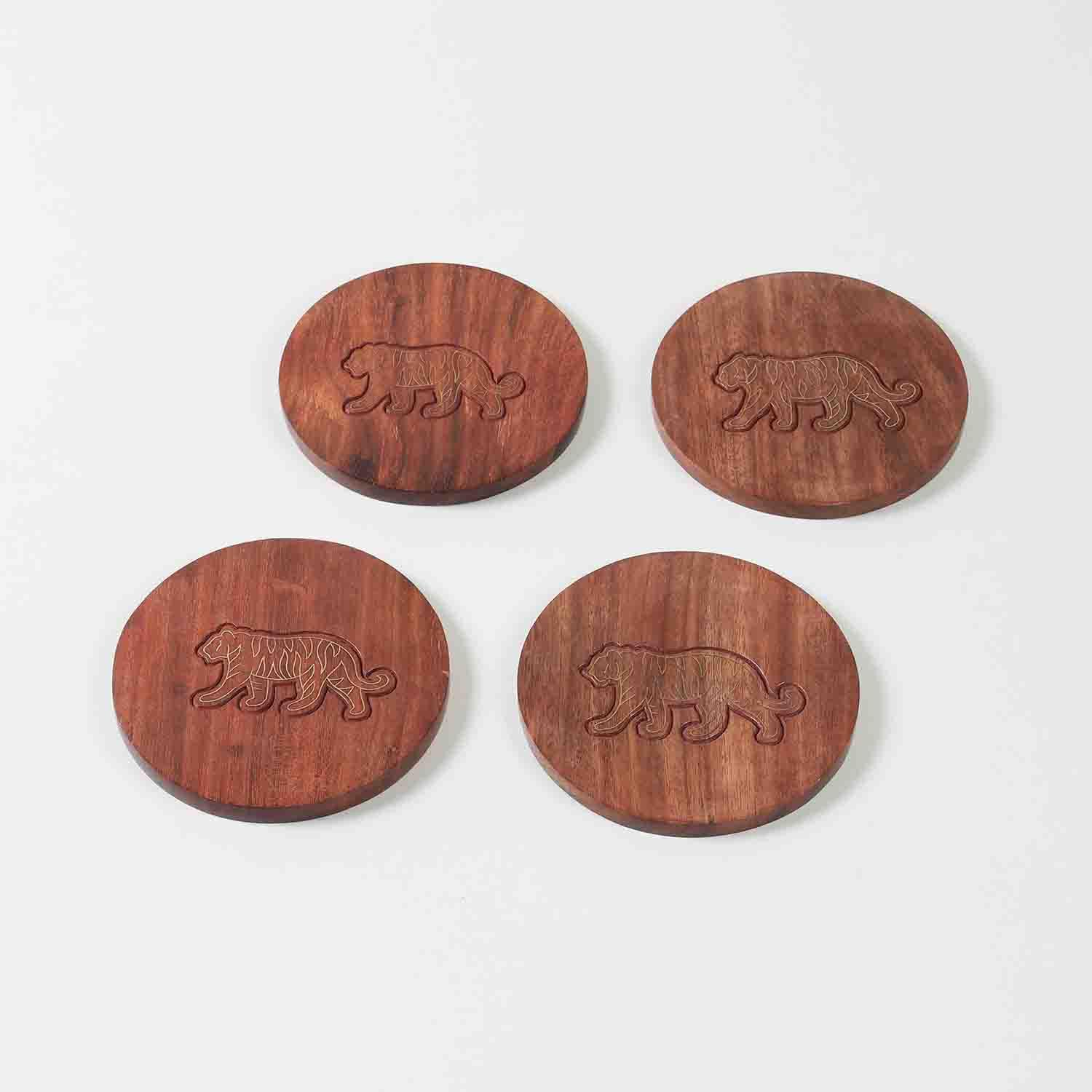 Set of four handcrafted rosewood coasters featuring tiger brass inlay detailing displayed against a clean background