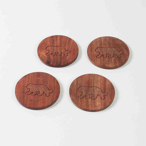 Set of four handcrafted rosewood coasters featuring tiger brass inlay detailing displayed against a clean background