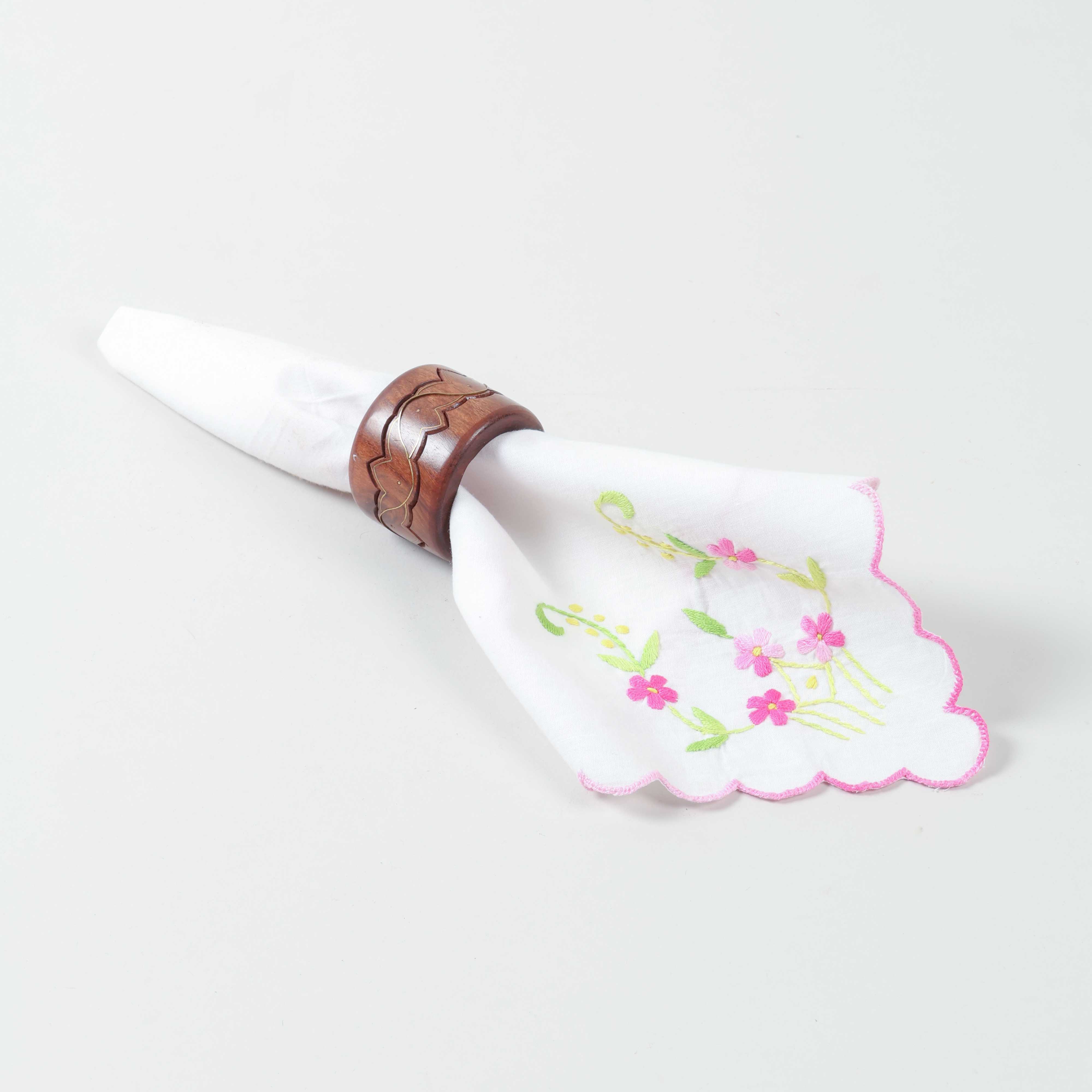 Handcrafted round wooden napkin ring with lotus brass inlay holding a table napkin for elegant dining decor