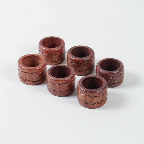 Set of six round wooden napkin rings featuring lotus inspired brass inlay and handcrafted detailing