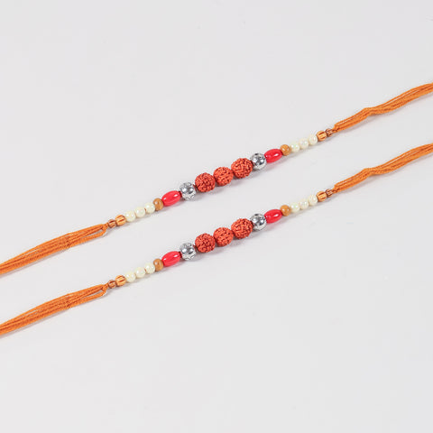 Close-up of the Handmade Rudraksha & Bead Rakhi featuring natural Rudraksha, faux pearls, red beads, decorative glass and wooden beads, and antique-finish metal spacers