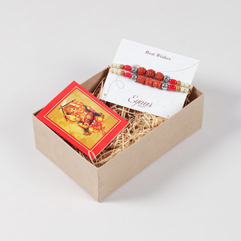 Handmade Rudraksha with Red and Pearl Bead Rakhi Set of 2 neatly arranged inside a decorative Raksha Bandhan gift box.