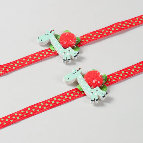 Close-up of the handmade Set of 2 Giraffe Wooden Kids Rakhi with colourful red ribbon and giraffe design.