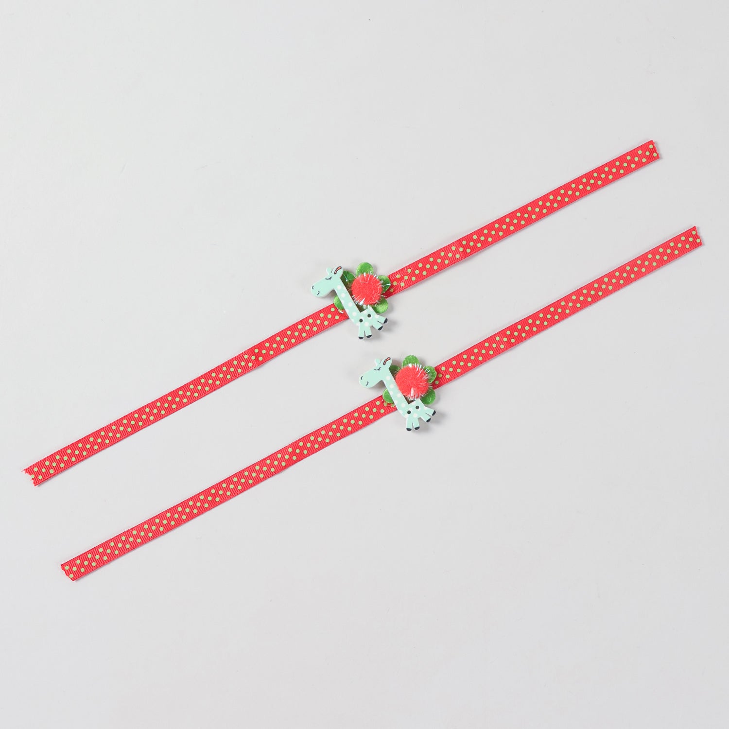 Full-length view of the set of 2 Giraffe Wooden Kids Rakhi showing the complete red ribbon and handcrafted details