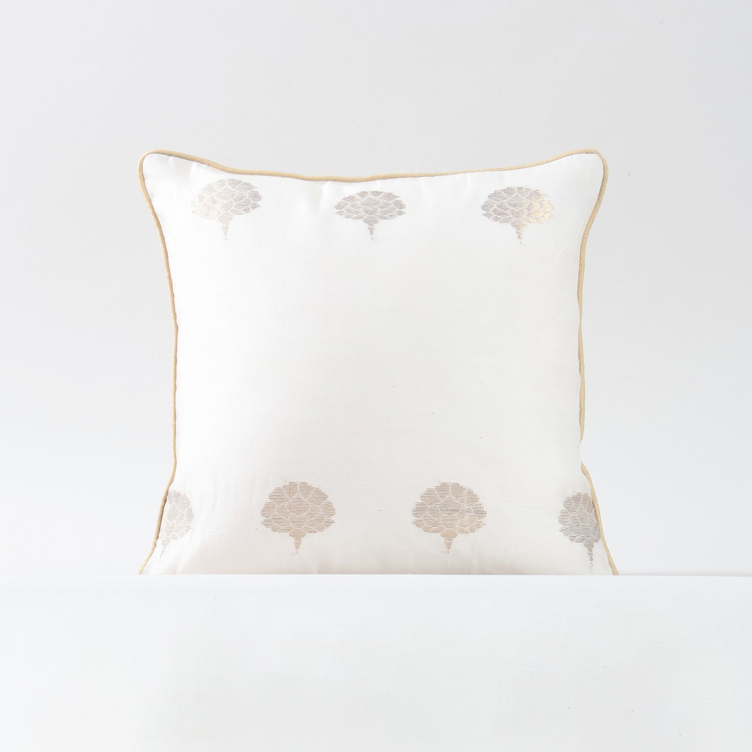 Single off-white Chanderi cushion cover with woven tree motifs designed for elegant home styling
