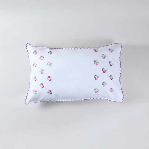 Cotton pillow case featuring delicate floral embroidery in purple pink and yellow on a white base