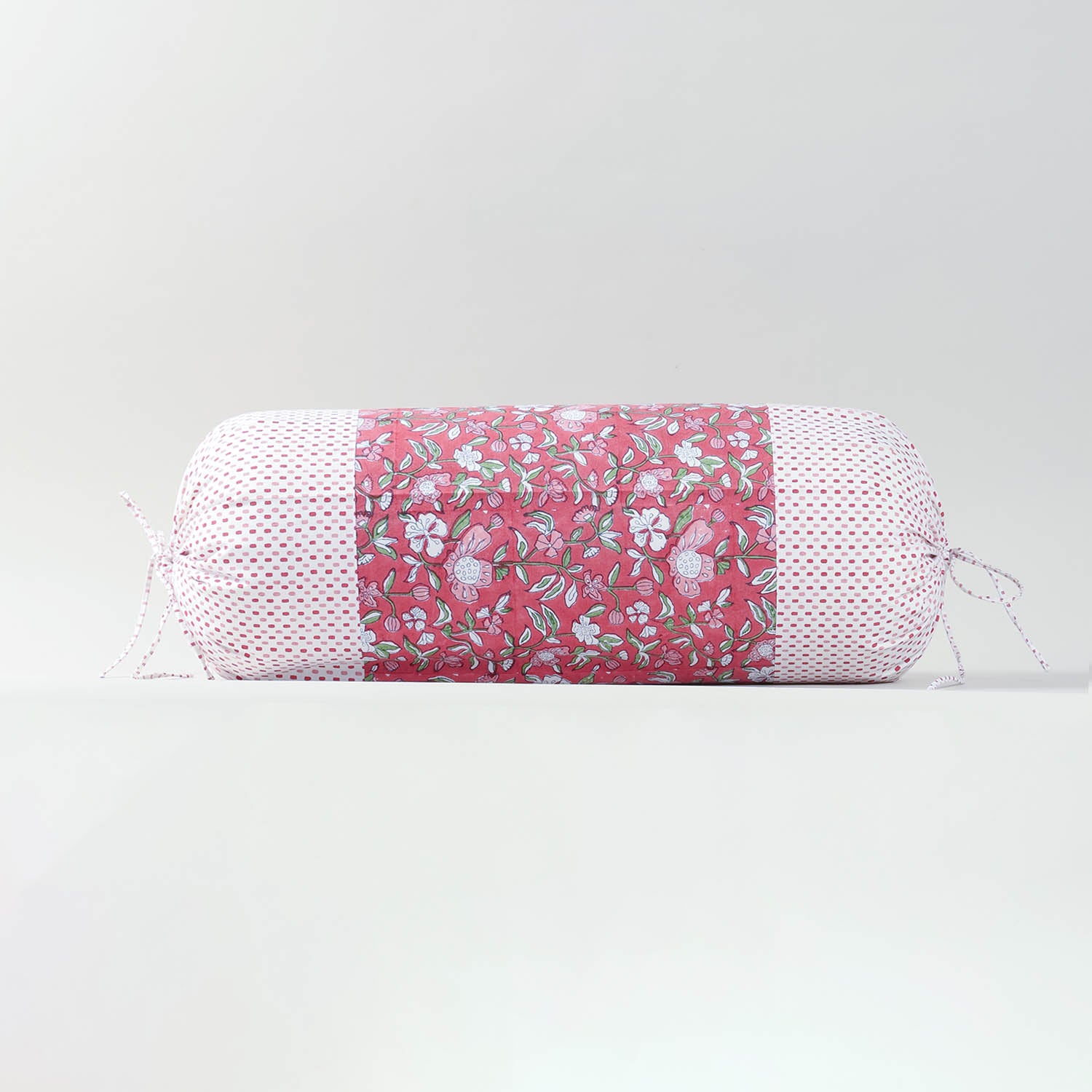 Single hand block printed bolster cushion cover in red, designed for beds, sofas and decorative seating arrangements