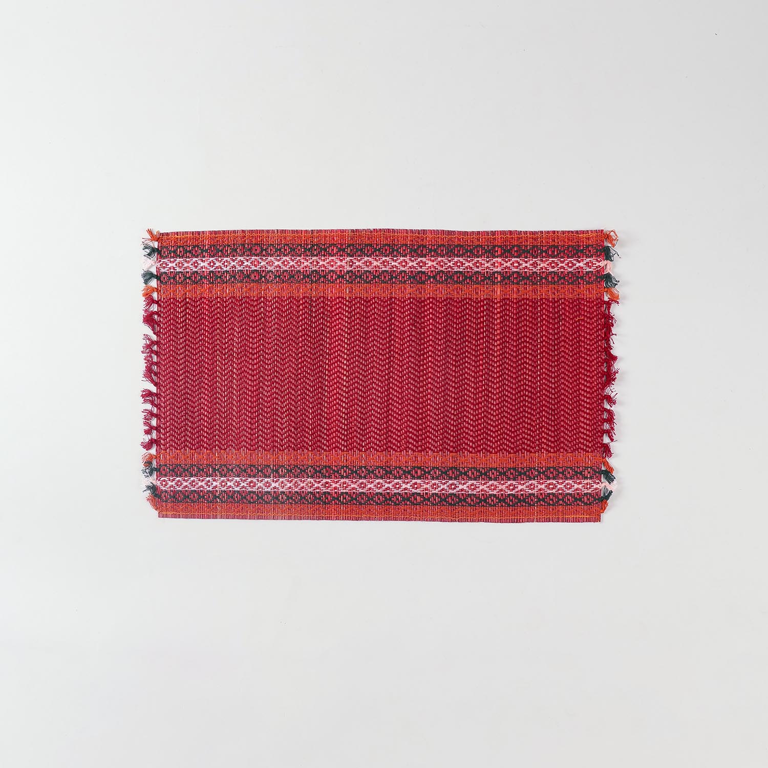 Single handmade red Madhurkathi placemat crafted from natural river grass, ideal for dining table décor and everyday use
