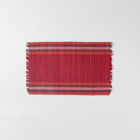 Single handmade red Madurkathi placemat crafted from natural river grass, ideal for dining table décor and everyday use
