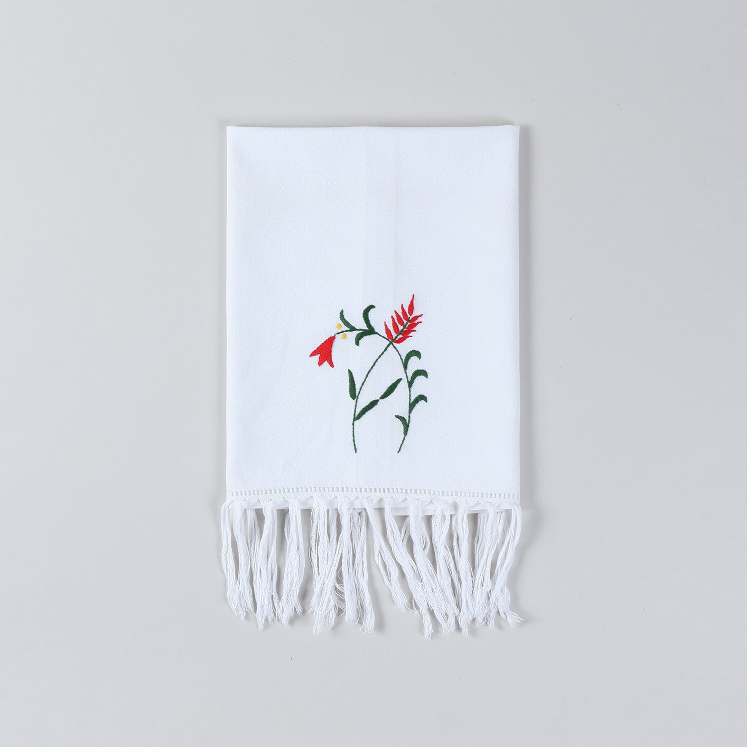 White cotton kitchen towel with red and green floral embroidery inspired by Bengal chikankari craftsmanship
