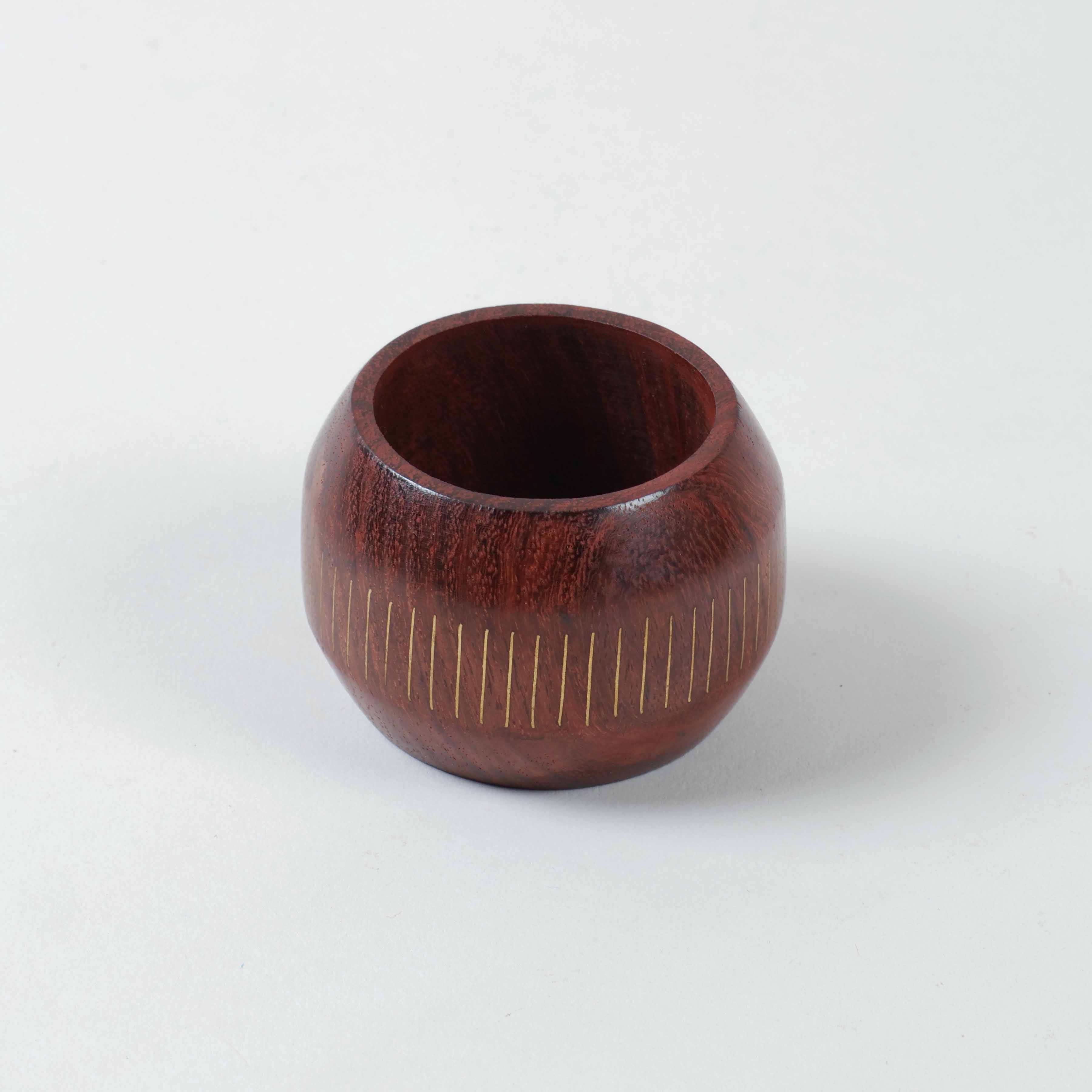 Round wooden napkin ring with linear brass inlay inspired by classic railroad patterns