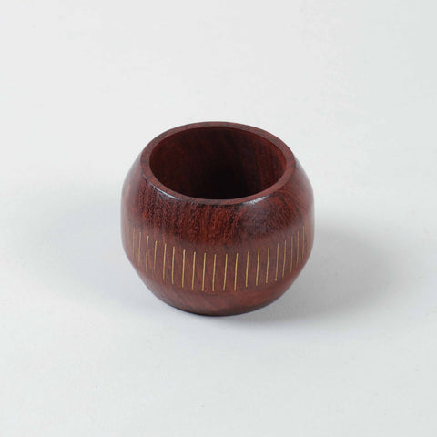 Round wooden napkin ring with linear brass inlay inspired by classic railroad patterns
