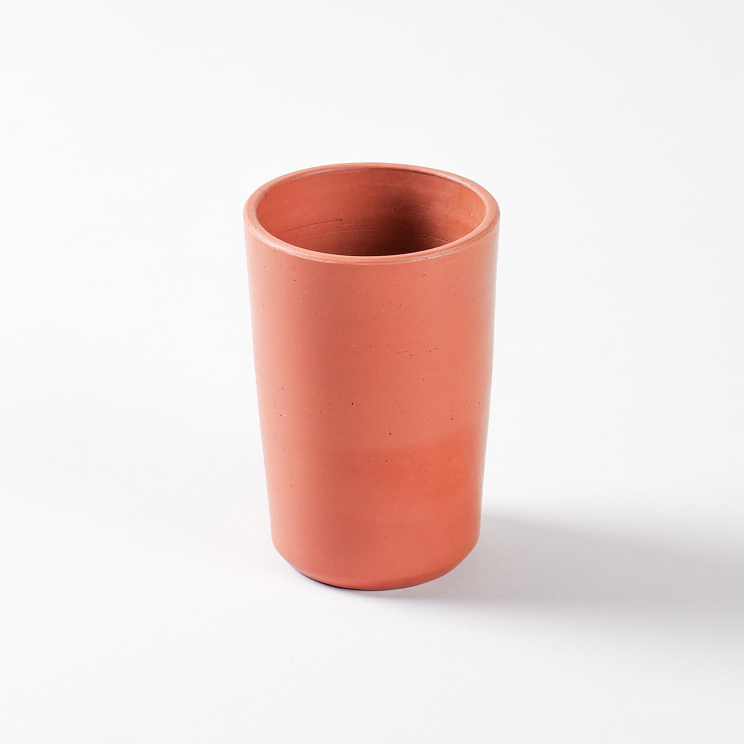 Single handmade terracotta tumbler crafted from natural clay for ecofriendly everyday drinkware