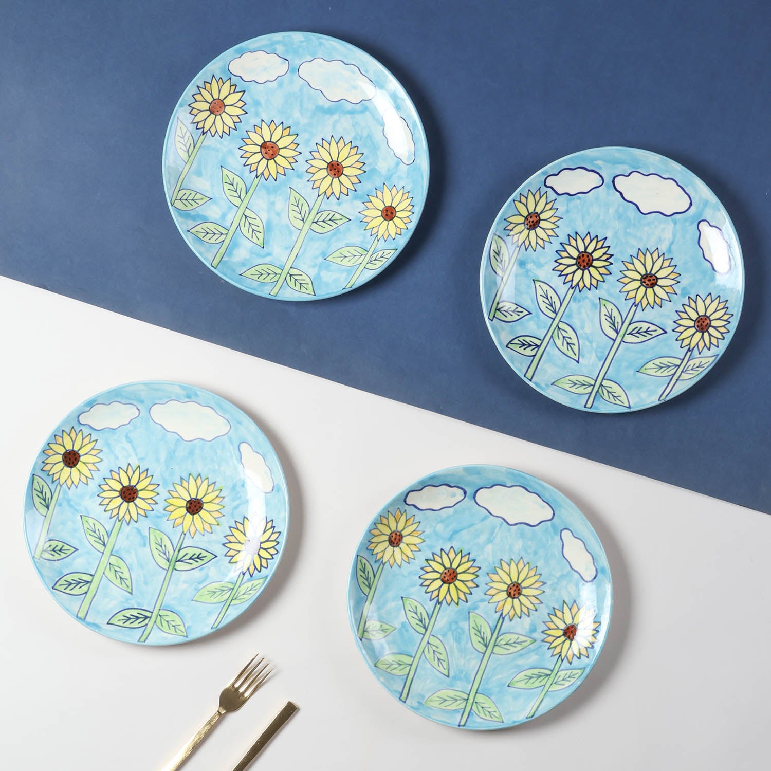 Hand-painted Sunflower ceramic dinner plate set of 4 featuring a light blue background and vibrant sunflower motifs, styled for elegant table settings