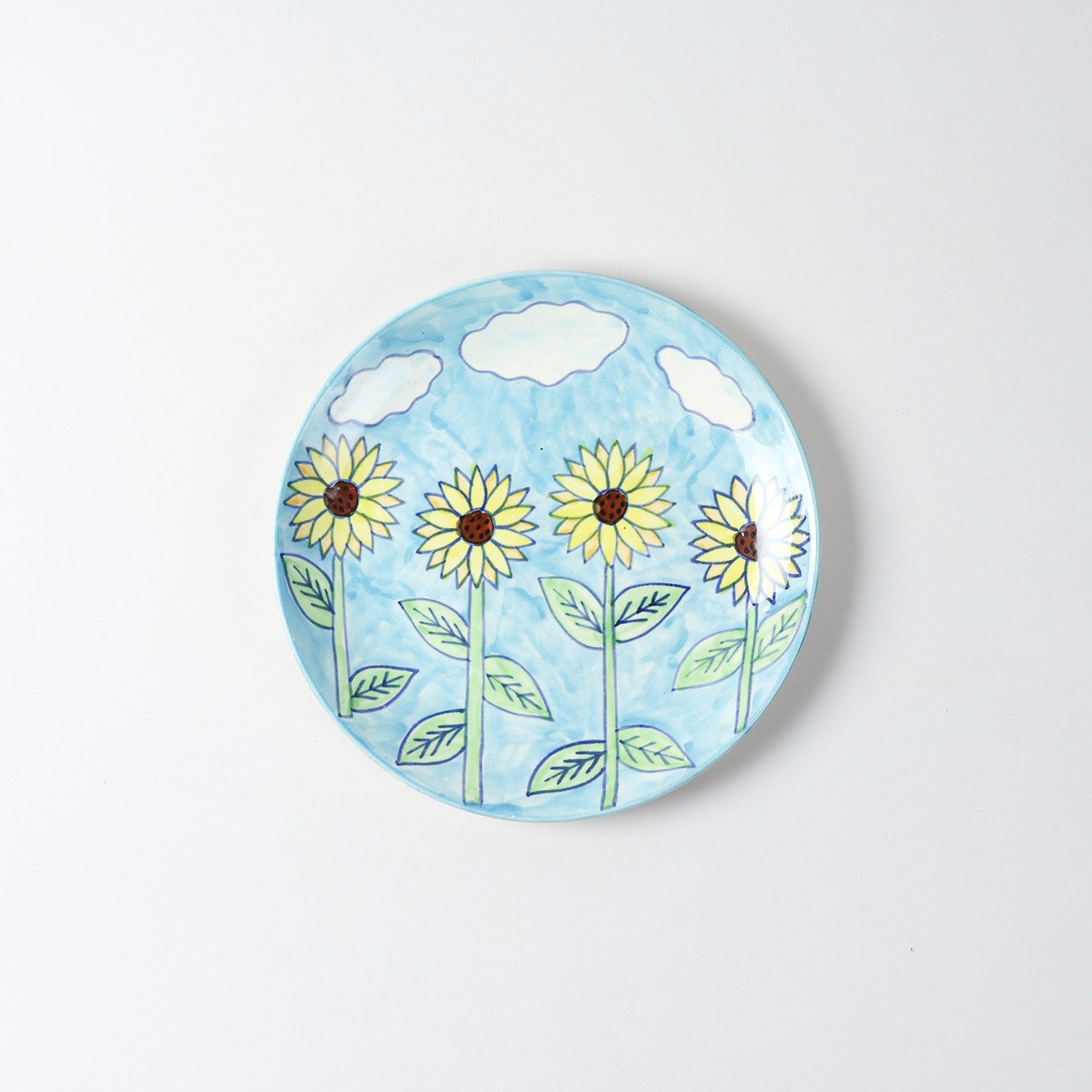 Hand-painted Sunflower ceramic dinner plate featuring a light blue background and vibrant sunflower motifs, ideal for everyday dining and serving