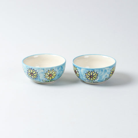  Hand-painted Sunflower ceramic katori set of 2 placed side by side on a plain background, featuring blue, yellow, and brown floral artwork from Khurja ceramics