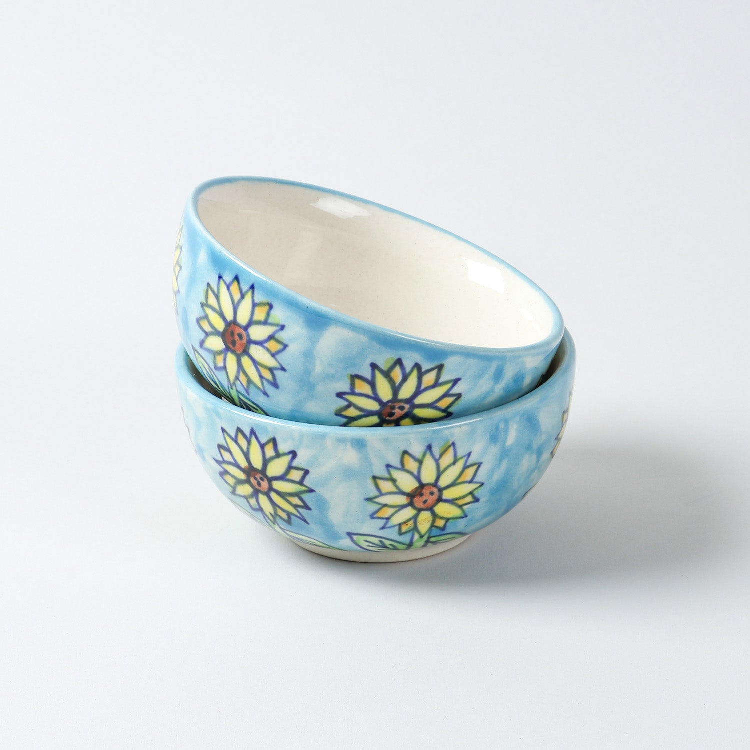 Handmade Sunflower ceramic portion bowls arranged in a stacked display on a plain background, showcasing vibrant floral artwork and glossy finish