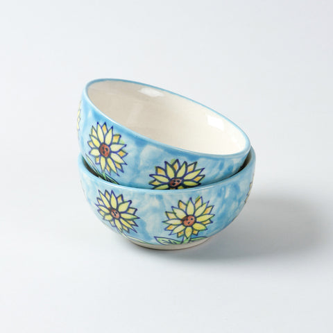 Handmade Sunflower ceramic portion bowls arranged in a stacked display on a plain background, showcasing vibrant floral artwork and glossy finish