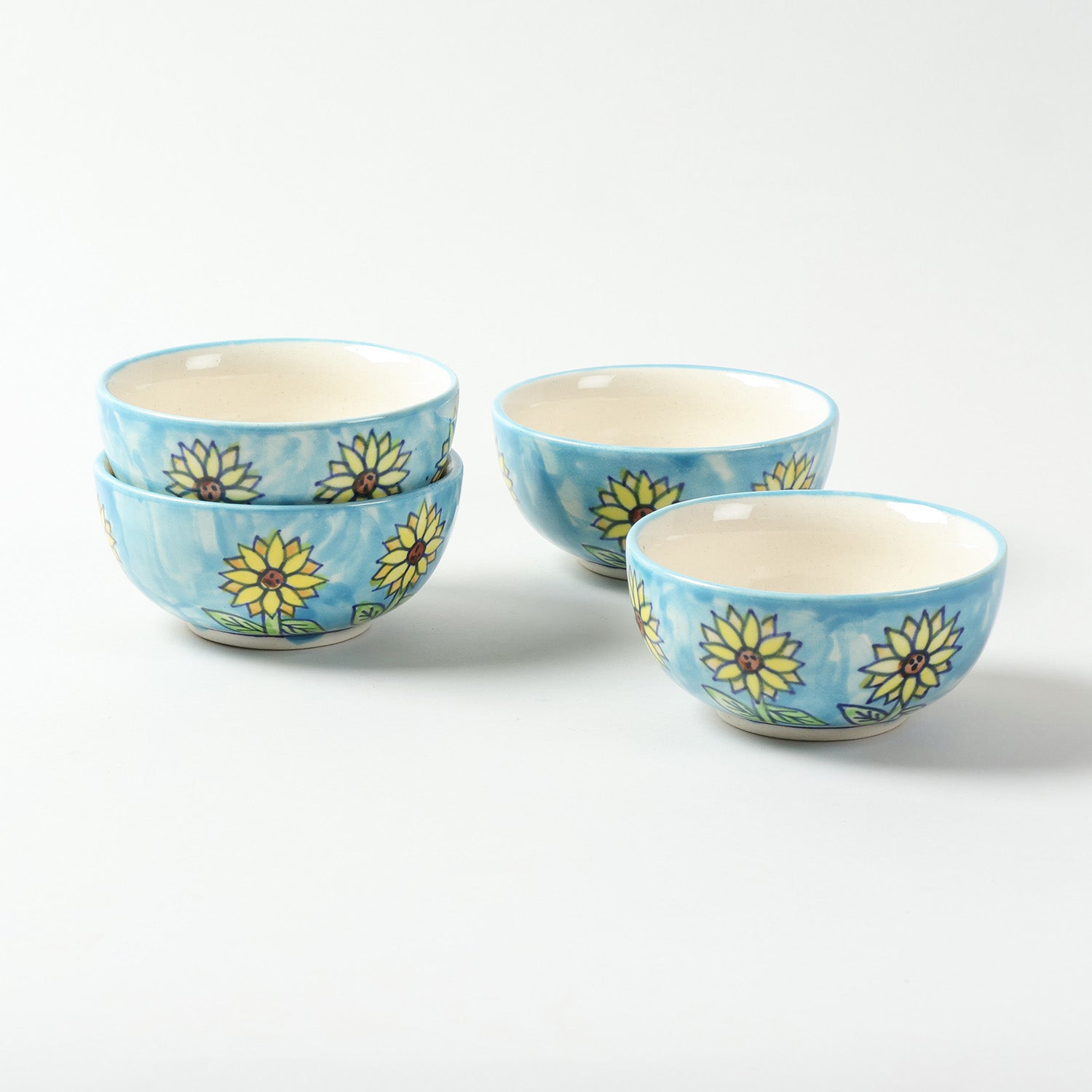Hand-painted Sunflower ceramic katori set of 4 displayed on a plain background, featuring colourful floral motifs and handcrafted Khurja ceramic artistry