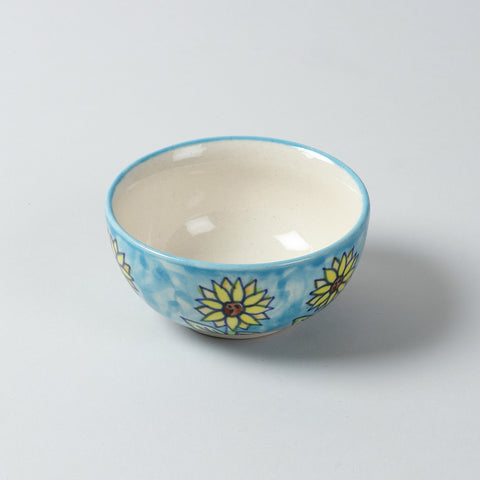 Single hand-painted Sunflower ceramic katori bowl featuring blue, yellow, and brown floral motifs on a plain background