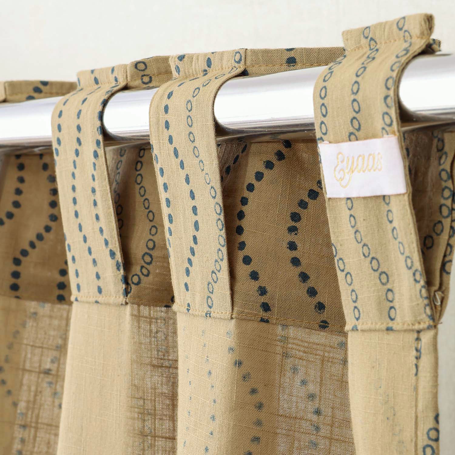 Tab top hand block printed beige cotton curtains for easy hanging and elegant window styling.