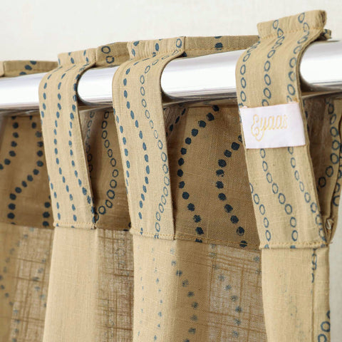 Tab top hand block printed beige cotton curtains for easy hanging and elegant window styling.