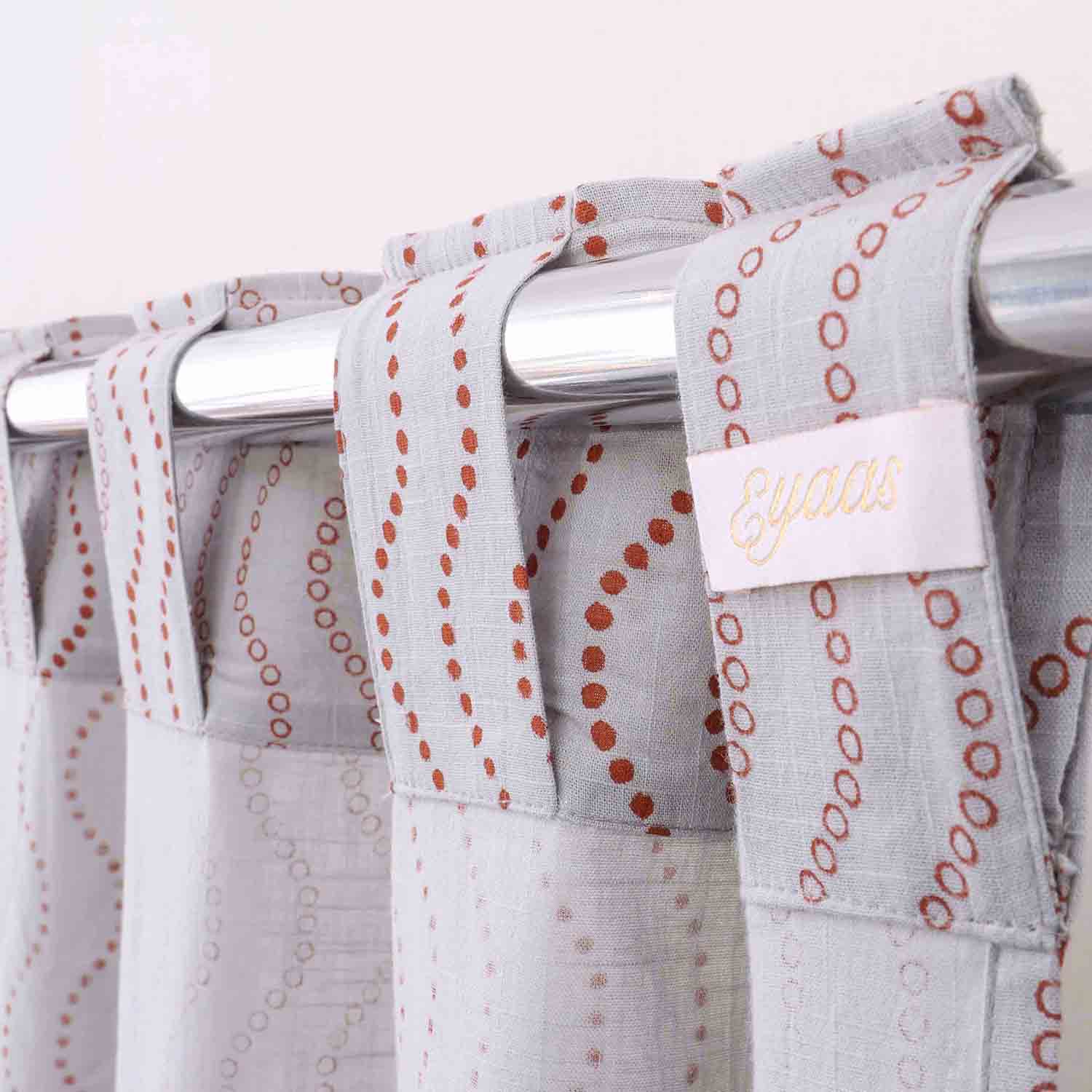 Tab top hand block printed cotton curtains for easy hanging and elegant window styling.