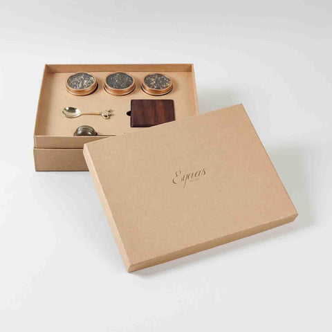 Tea gift set with tea accessories and wooden coasters packed in a premium gift box