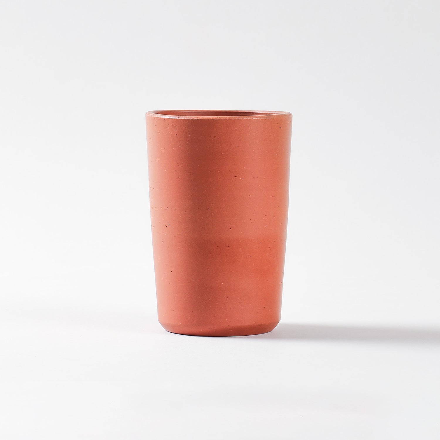 Traditional terracotta glass with natural earthen finish for serving water and refreshing drinks