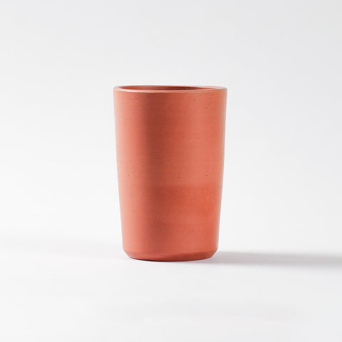 Traditional terracotta glass with natural earthen finish for serving water and refreshing drinks