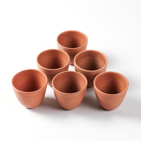 High-angled view of the conical terracotta kulhad cups set handcrafted in India.